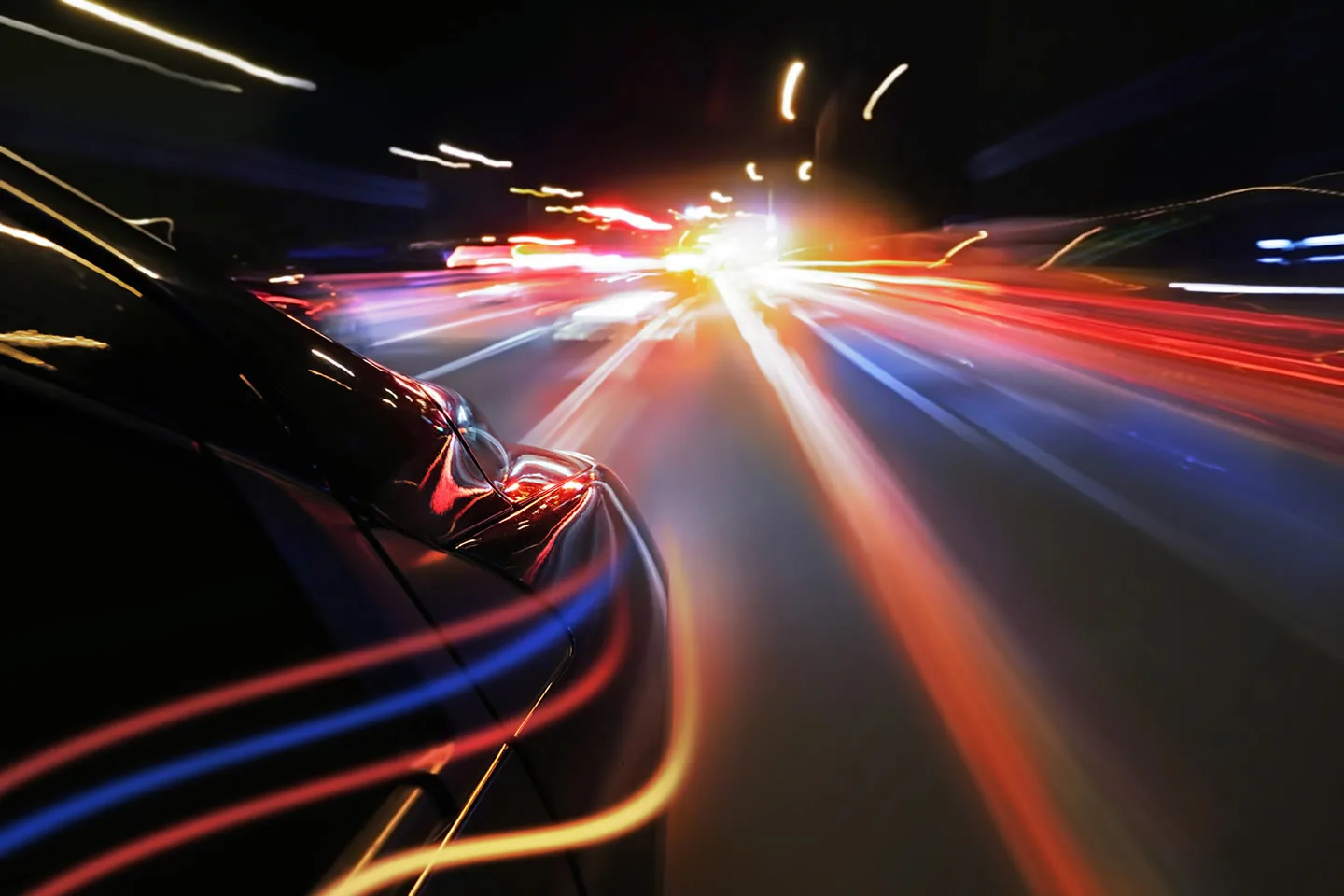 A car moving through lights at night.